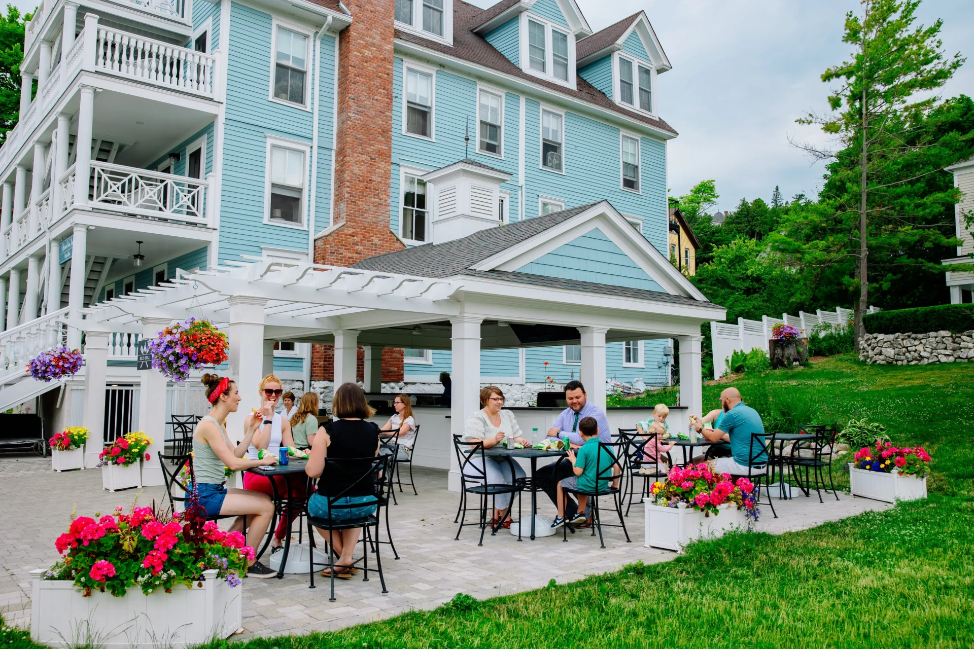 People eating on a patio of the Harborview Hotel.