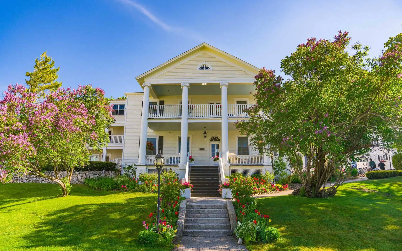 The front side of the Harbor View Hotel with a front lawn and tree.